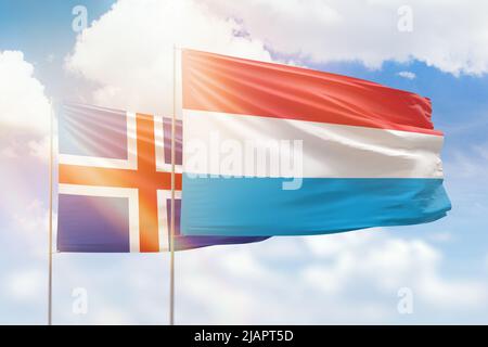 Sunny blue sky and flags of luxembourg and iceland Stock Photo