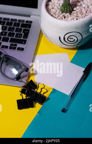 Office desk with yellow stickers, coffee and laptop. Top view flat lay with copy space Stock Photo