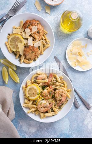 Chicken and shrimp piccatta with penne pasta Stock Photo