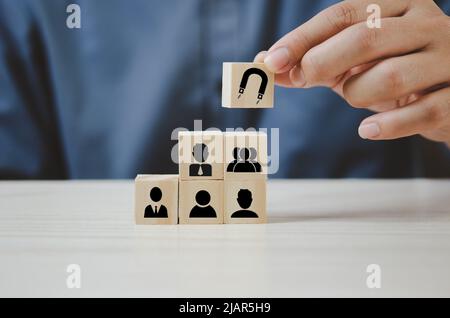 Hand put wooden cubes with Inbound marketing icons and symbols on table and copy space.Business concepts. Stock Photo