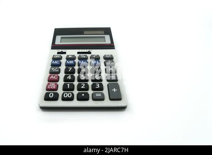 Perspective view a small old-style calculator on white background, calculator with old-style button and some marks from using. Stock Photo