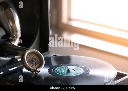 antique portable gramophone with a powder covered vinyl record Stock Photo