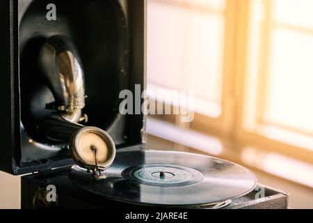 antique portable gramophone with a powder covered vinyl record Stock Photo