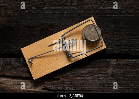 Russian rubles in a mousetrap on a wooden background. Financial sanctions against Russia. The collapse of the ruble. Russian economy and ruble. Crisis Stock Photo
