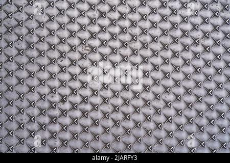 background created with geometric pattern of spikes on metal background Stock Photo