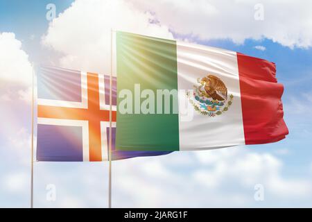 Sunny blue sky and flags of mexico and iceland Stock Photo