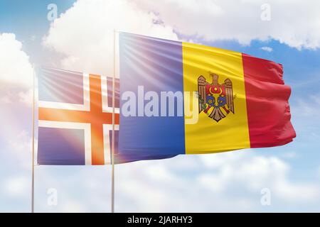 Sunny blue sky and flags of moldova and iceland Stock Photo