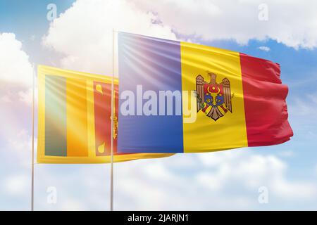 Sunny blue sky and flags of moldova and sri lanka Stock Photo