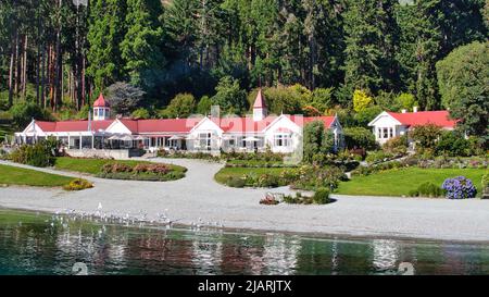 View from Lake Wakatipu of the buildings of Walter Peak Farm near Queenstown New Zealand Stock Photo