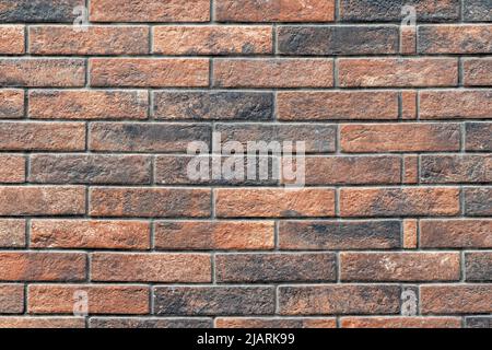 Brick wall background of red and black bricks neatly arranged. Stock Photo