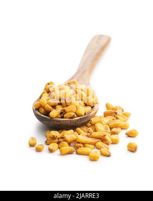 Roasted salted corn snack in wooden spoon isolated on a white background. Stock Photo