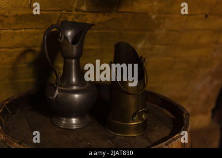 Set of five antique pewter jugs of different sizes. Stock Photo