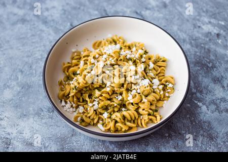 vegan spinach and dairy-free ricotta pasta bowl with wholemeal spirals, healthy plant-based food recipes Stock Photo