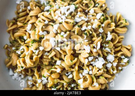 vegan spinach and dairy-free ricotta pasta bowl with wholemeal spirals, healthy plant-based food recipes Stock Photo