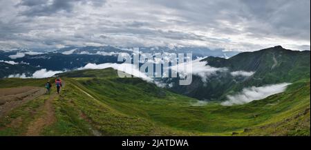 Amazing mountain landscape in Georgia on sunny summer day. Alpine green meadow in Caucasus highlands. Idyllic valley in Svaneti mountains. Stock Photo