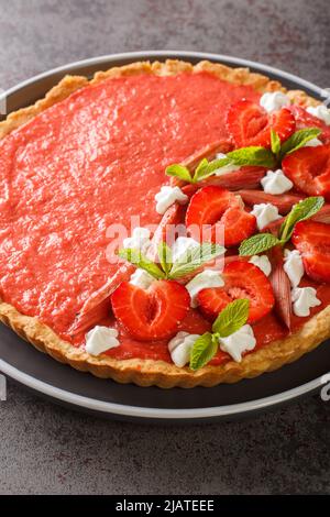 rhubarb strawberry tart with mousse close-up on the table. Vertical Stock Photo
