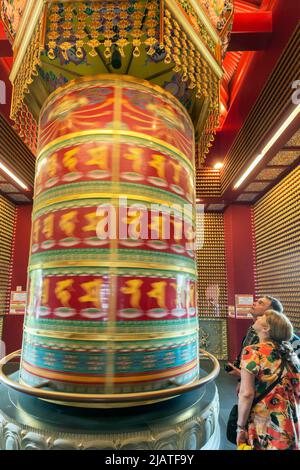 Prayer wheel in movement, Buddha Tooth Relic Temple and Museum Republic of Singapore. Stock Photo