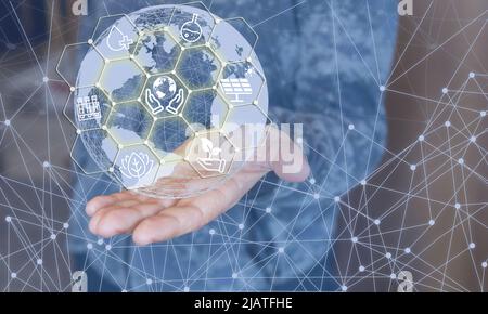 A hand holding a globe. Green planet concept. Understanding the need not to pollute the environment. Stock Photo