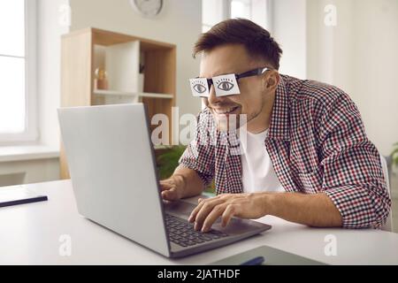 Man sleeping at work with fake eyes painted on paper sticker, covered his  eyes Stock Photo by sofiiashunkina