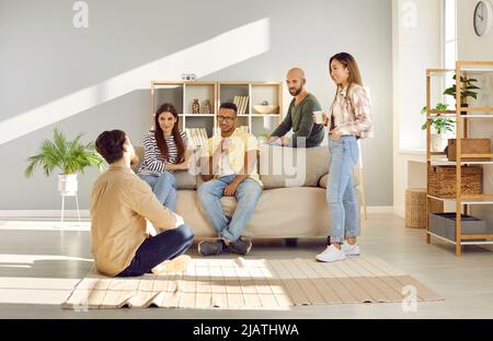 Smiling diverse employees talk at coffee break in office Stock Photo