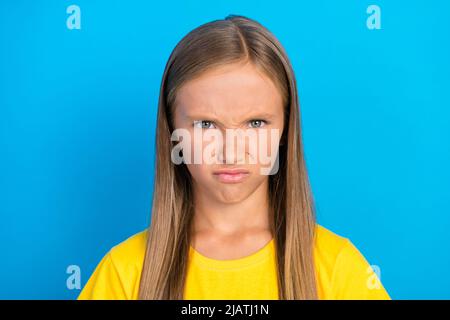 Photo of grumpy frustrated small lady frowning face grimace wear yellow t-shirt isolated blue color background Stock Photo