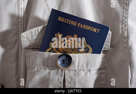 new british passport in cream safari jacket pocket Stock Photo