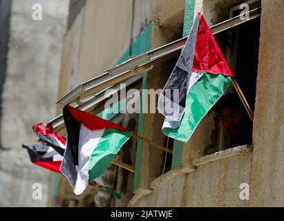 May 29, 2022, Gaza City, Gaza Strip, Palestine: Gaza, Palestine, 29 May 2022. Palestinians wave their national flag in Gaza City to protest against the Israeli Flag March through Jerusalem Old City on Sunday. The Flag March is an annual event marking Israel's capture of East Jerusalem in 1967, with right-wing Israeli nationalists singing and dancing during the rally and insulting Palestinians. The already high tension in the region was increased by the storming by Israeli ultra-nationalists and Israeli settlers of the Al-Aqsa Mosque compound both before and during the march (Credit Image: © Stock Photo