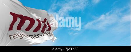 official flag of Region Midtjylland , Denmark at cloudy sky background on sunset, panoramic view. Danish travel and patriot concept. copy space for wi Stock Photo