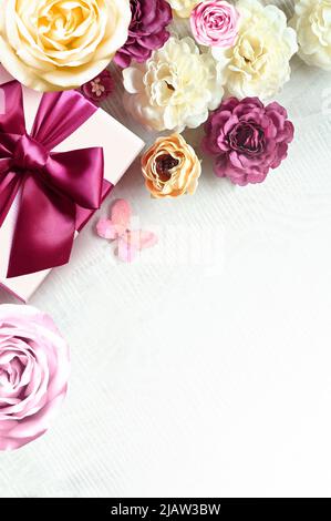 Colorful roses and gift box on white background. Beautiful, good for holidays and gift. Flowers pattern. Stock Photo