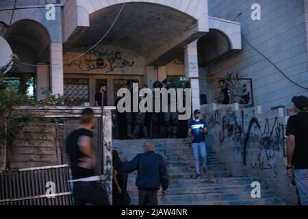 Israeli Border Police soldiers seen at the entrance of a house in Sheikh Jarrah after Israeli Youth broke in it. About 70,000 right-wing Israelis participated in one of the biggest flag marches during Jerusalem Day celebrations. Jerusalem Day marks the unification of the city in the 1967 Israel - Arab war. The march passed through Damescus Gate and the Old City. Throughout the day violent clashes occurred between Palestinians and the Israeli participators. (Photo by Matan Golan / SOPA Images/Sipa USA) Stock Photo