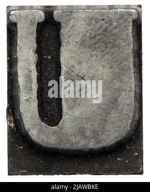 close up macro metal lead letter of printing house for text setting against white background showing capitol U Stock Photo
