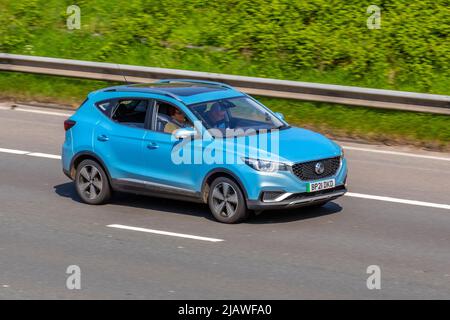 2021 blue MG ZS EXCLUSIVE EV Electricity 1 speed automatic, driving on the M6 Motorway, UK Stock Photo