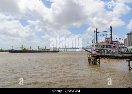 NEW ORLEANS, LA, USA - APRIL 23, 2022: The riverboat City of New Orleans and the bulk carrier Viyada Naree on the Mississippi River with the Crescent Stock Photo