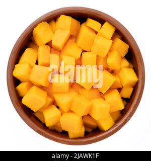 Raw Pumpkin cut into pieces in a bowl isolated on a white background, top view Stock Photo
