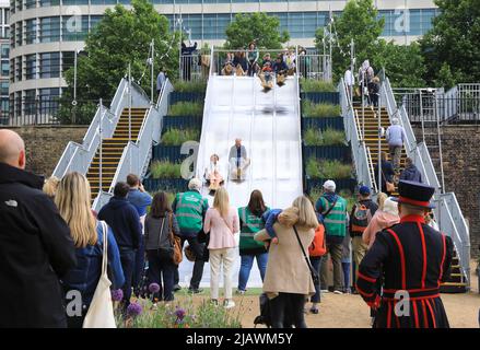 London, UK, 1st June 2022. Superbloom opens at the Tower of London, to celebrate the Queen's Platinum Jubilee, with 20 million wildflowers planted and designed to attract pollinators. The slide down into the moat proved popular with families! Credit :Monica Wells/Alamy Live news Stock Photo
