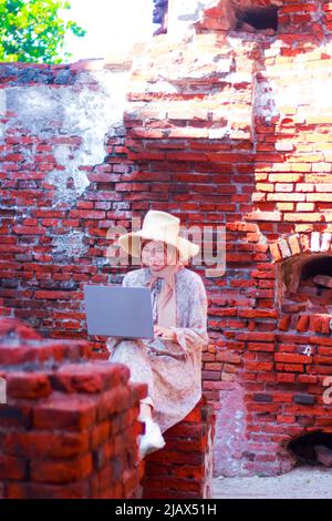 A woman do work from anywhere at Kepulauan Seribu, Jakarta. Stock Photo