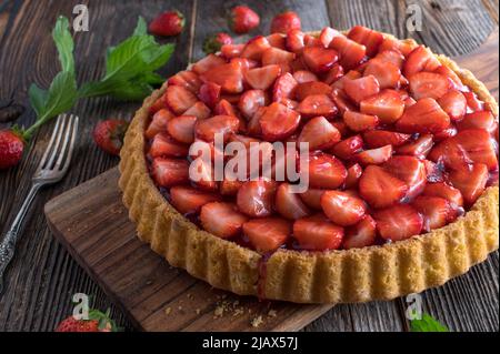 Strawberry pie on wooden table. Fresh and homemade baked Stock Photo