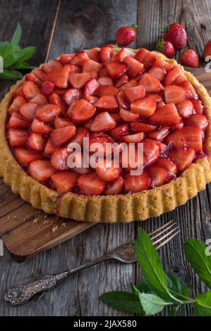 Strawberry tart on wooden table. Traditional german fruitcake Stock Photo