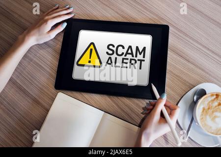 Scam alert detecting warning. Notification on device screen. Stock Photo