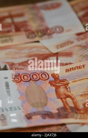 Russian paper banknotes with nominal value of five thousand rubles close-up view from above. Economics and finance of Russian Federation. Largest bill Stock Photo