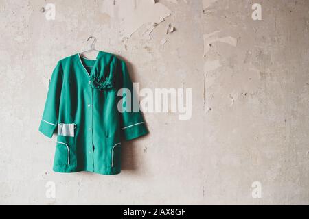 Ukraine nurse costume hanging on a white old wall in a house Stock Photo