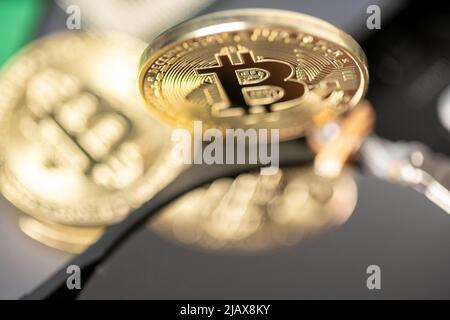 Bitcoin reflection on hard drive platter. Mining cryptocurrency concept. PC hardware with digital currency like bitcoin. Closeup of BTC gold coin Stock Photo