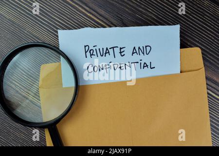 Private and Confidential text on document above brown envelope and stethoscope. Healthcare or medical concept Stock Photo