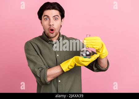 Photo of young shocked amazed excited man hold hand chemical wear gloves isolated on pink color background Stock Photo