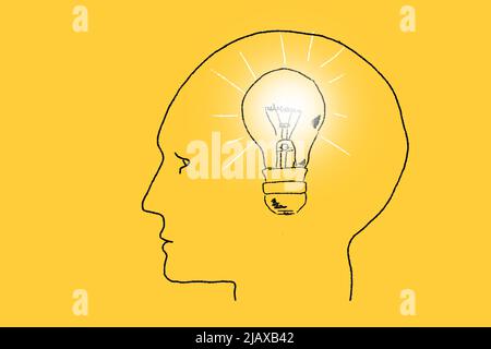 Human head silhouette with light bulb inside. Symbol of a new idea. Hand drawn illustration on yellow. Stock Photo