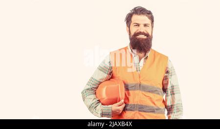Builder in hard hat, foreman or repairman in the helmet. Bearded man worker in building helmet or hard hat. Portrait of a builder smiling. Worker in Stock Photo