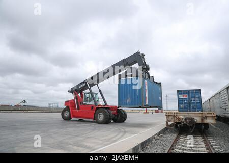 Nairobi, Kenya. 18th May, 2022. A worker unloads a container from a train in Nairobi freight terminal in Nairobi, Kenya, May 18, 2022. TO GO WITH 'Roundup: Chinese-built modern railway powering Kenya's growth, renewal as it marks five years' safe operation' Credit: Long Lei/Xinhua/Alamy Live News Stock Photo