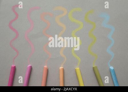 Close up view colorful pastel crayons and pigments on begie background Stock Photo
