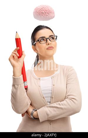 Young female professor with a big red pencil thinking and a brain floating above her head isolated on white background Stock Photo