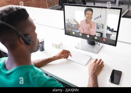 African american male and female colleagues discussing during meeting on video conference in office Stock Photo